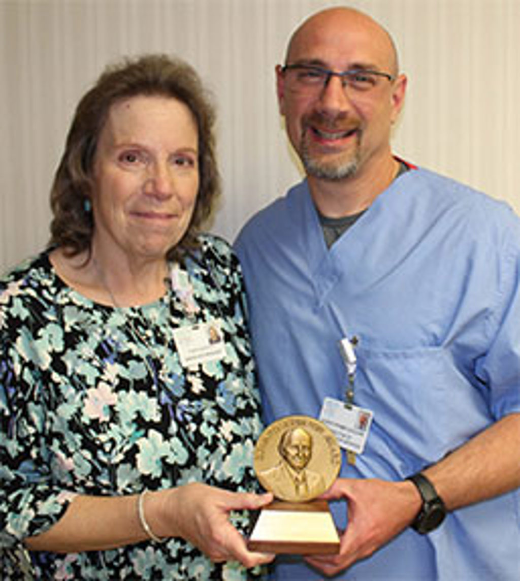 Donna L. Ramusivich accepts the 2021 Edward J. Protin Award from Christopher Coccari