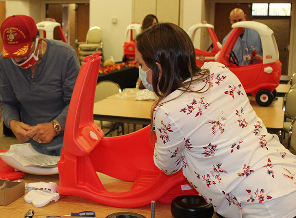 Marissa Dreucci eads the instructions on how to assemble a firetruck