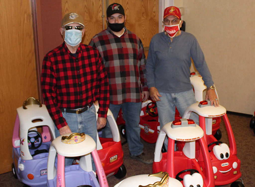 Bo Stoioff pose with a few of the vehicles assembled by MVH's Leadership Development Team