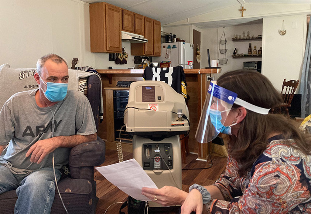 Kristy Taylor, MSW, meets with Greg Spencer in his home.