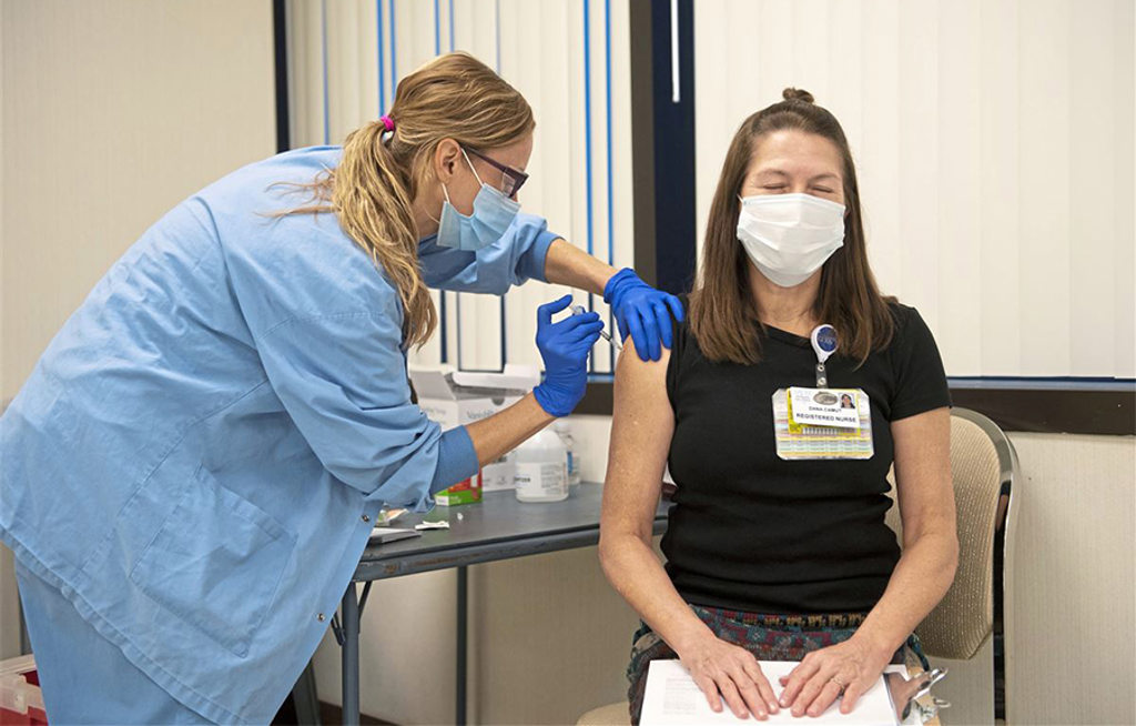 Sheila Amati administers the Pfizer COVID-19 vaccine