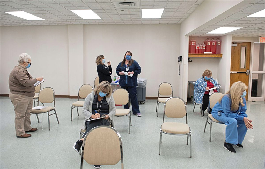 Patients filling out paperwork after receiving vaccine